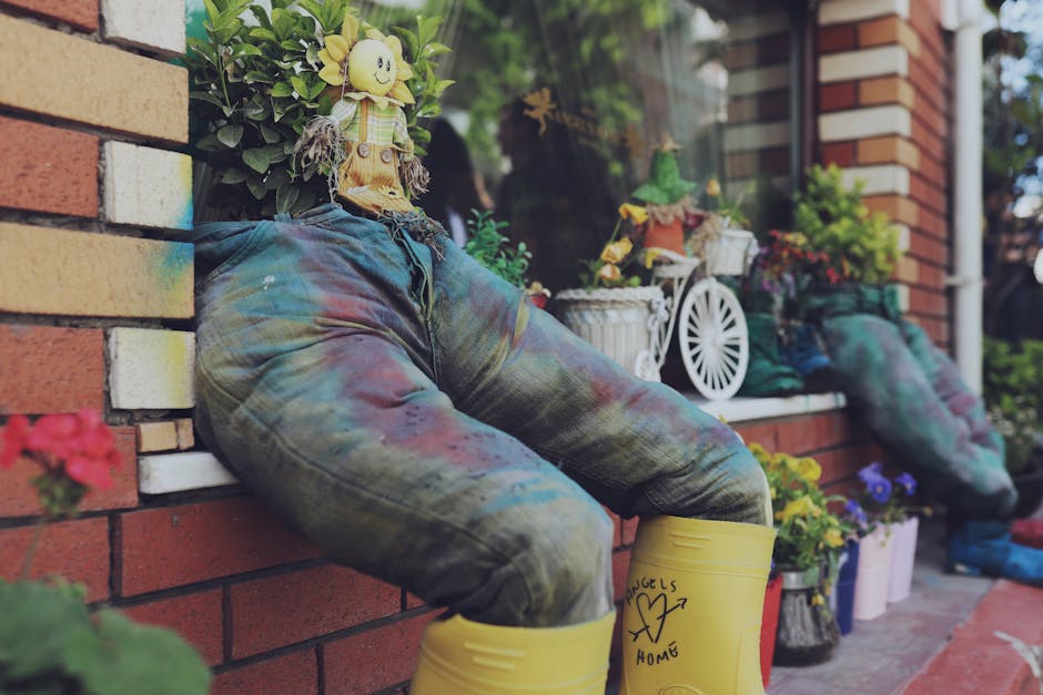 Whimsical garden decoration with jeans and yellow boots potted with greenery.