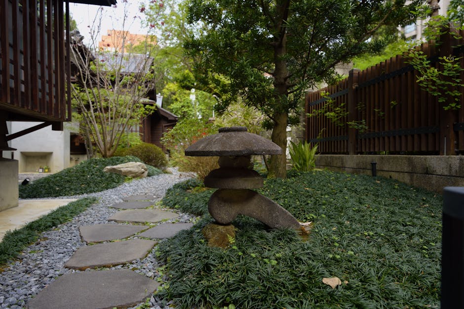 Tranquil stone path and lantern in a lush Japanese garden in Taipei.