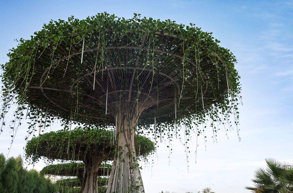 Innovative garden design featuring tall structures with cascading green vines against a clear sky.